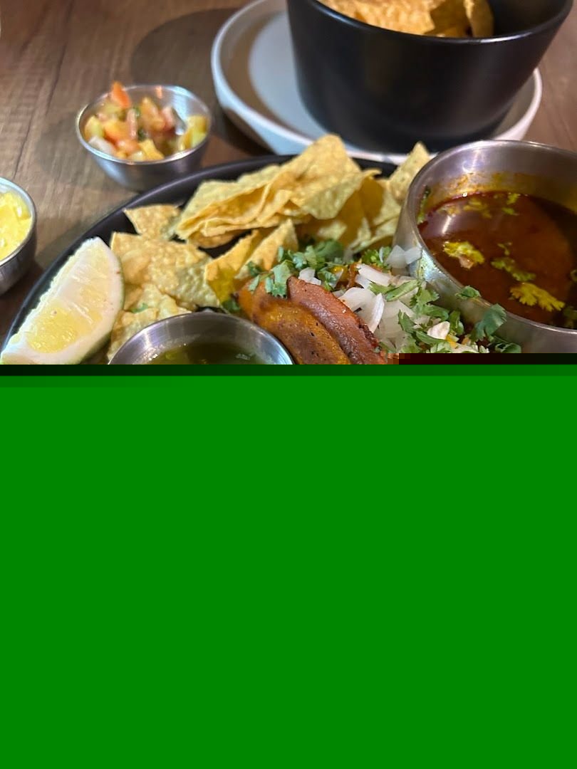 Molcajete platter with nachos, salsa, and smoked meat at La Guada Mas